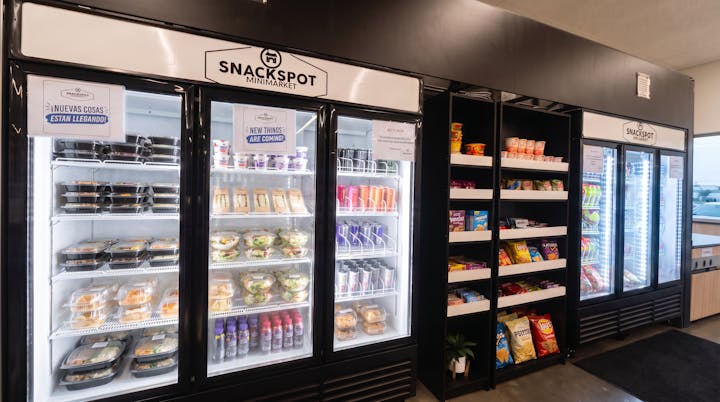 Refrigerated case stocked with prepared meals, sandwiches, yogurts and drinks.