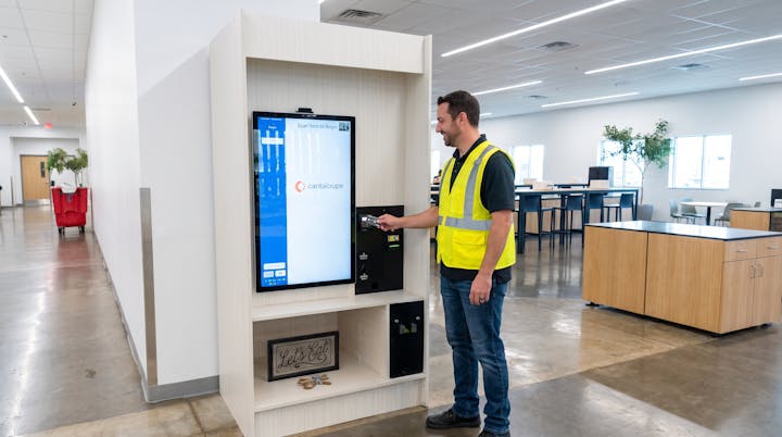 Worker paying at the SnackSpot self-checkout kiosk with a bank card.